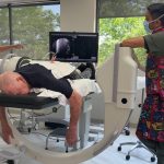 A doctor discussing pain management options with a patient after conservative treatments like yoga and physical therapy have failed.