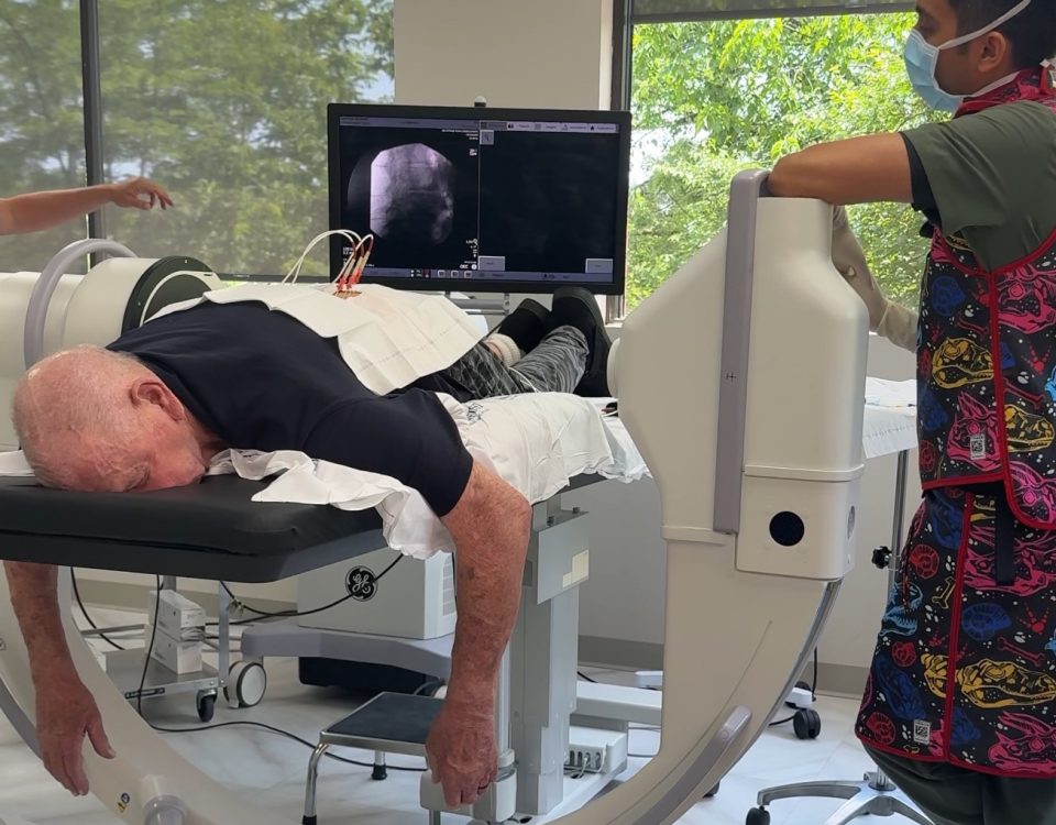 A doctor discussing pain management options with a patient after conservative treatments like yoga and physical therapy have failed.